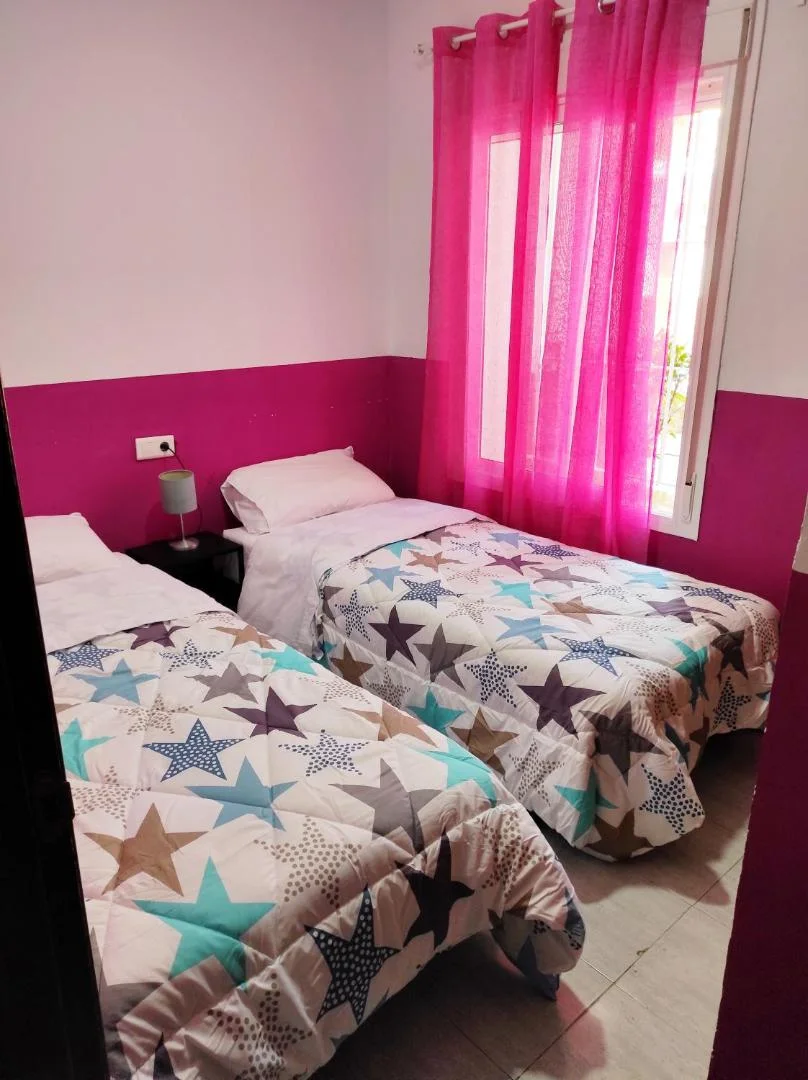 Dormitorio con dos camas y colchas de estrellas